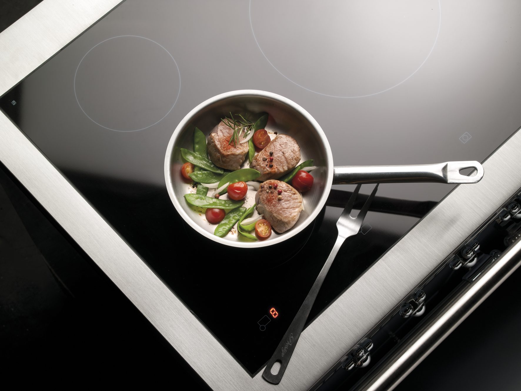 Lacanche induction hob with food being seared